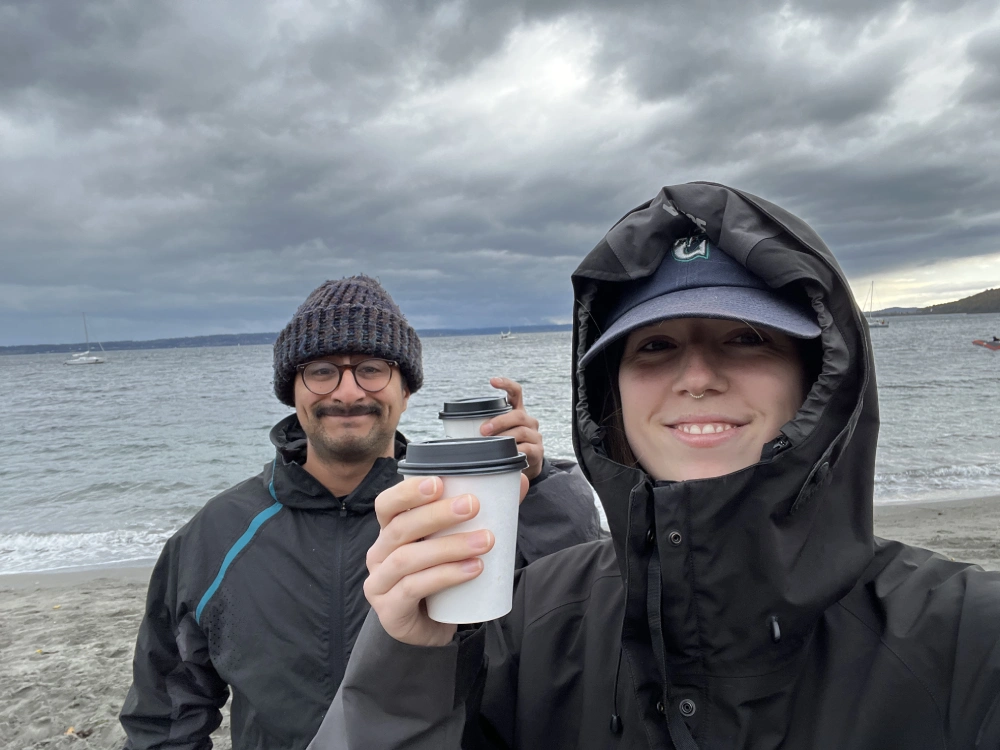 Jessica on a rainy beach day with coffee
